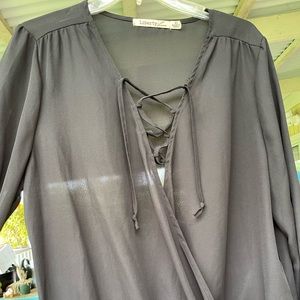 Black Polyester (chiffon like) wrap blouse.